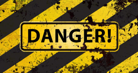 A yellow and black striped warning sign with the word “DANGER!” in bold black letters, symbolising the nervous system overreacting and constantly deciding that it's not safe.