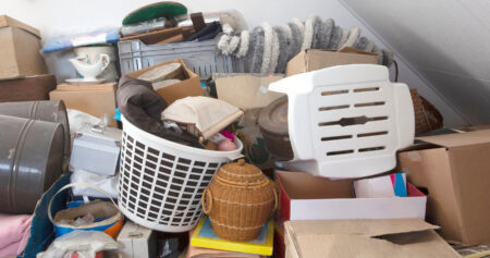 A cluttered attic filled with assorted possessions offers a glimpse into our relationship with stuff and sheds light on why we hoard belongings over the years.
